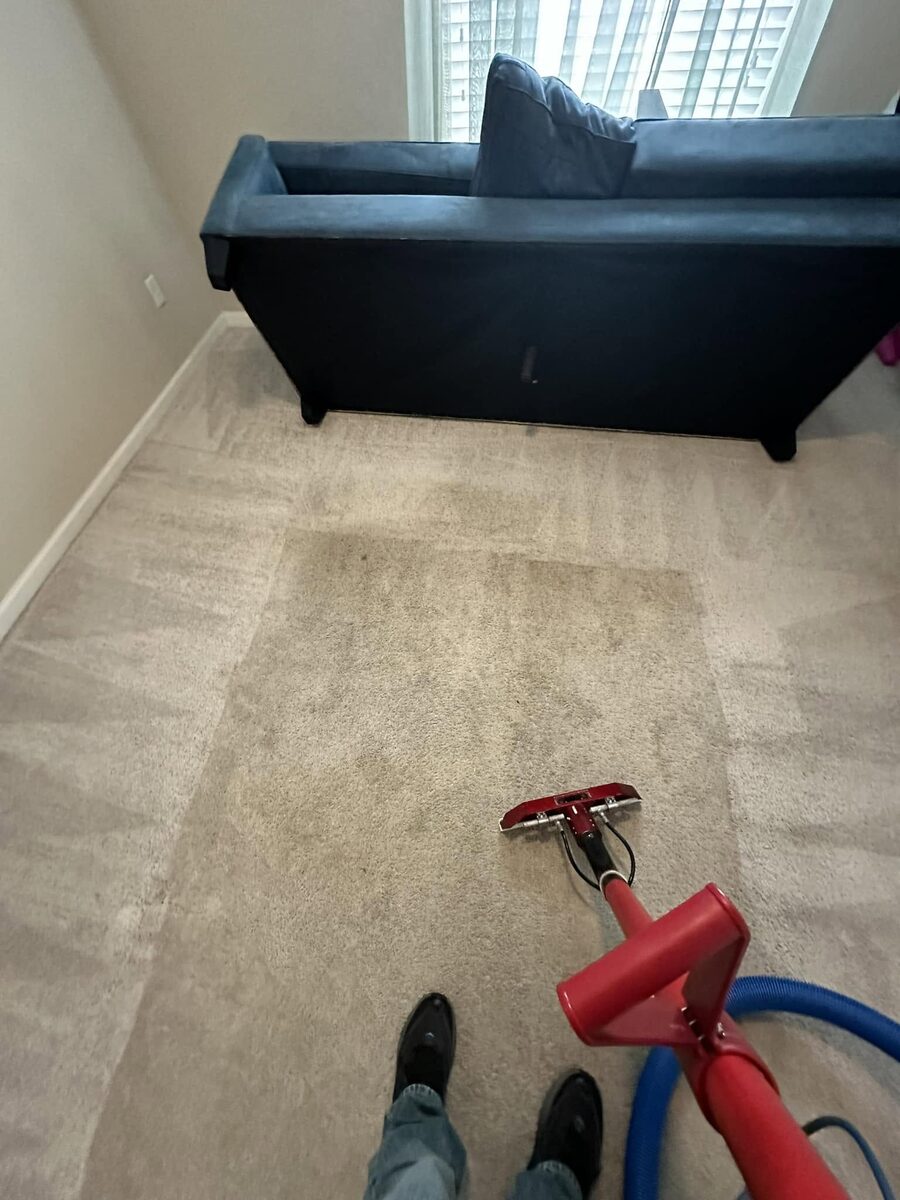 Carpet with a soiled area beside a cleaned wand path, from a Duval Floor Care Facebook job photo